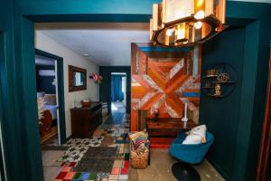 a living room with a blue wall and a blue chair at The Desert Shire Stargazing,Cold Plung & LargeSpa in Yucca Valley