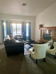a living room with couches and chairs and a fireplace at Casa Linda in Desert Hot Springs