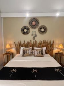 a bedroom with a large bed with a wooden headboard at Living Trawangan Hotel in Gili Trawangan +79 photos