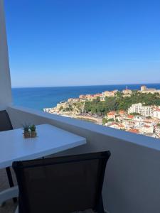 a table and chairs with a view of the ocean at Suka Apartments in Ulcinj