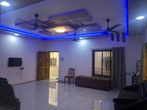 a living room with blue lights on the ceiling at Ishwar Villa in Arnālapāda