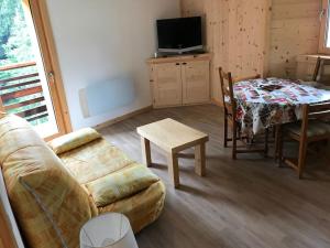 a living room with a couch and a table at FLUMET , Appartement Espace Diamant in Flumet