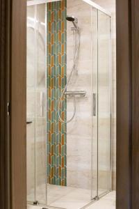 a shower with a glass door in a bathroom at Rossak apartment 2 in Panevėžys