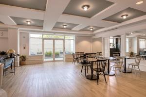 a dining room with tables and chairs and a large window at U Street 1br w gym wd nr metro dining WDC-676 in Washington