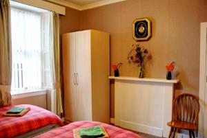 Postel nebo postele na pokoji v ubytování Atticus Central Guest House