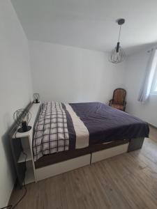 a bedroom with a bed in a white room at T2 Concoules - Panorama, Randonnées, Etapes motards in Concoules