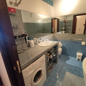 a bathroom with a washing machine and a sink at Stella Marina in Giardini Naxos +43 photos
