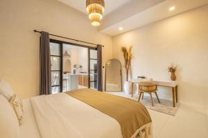 ein Schlafzimmer mit einem Bett, einem Schreibtisch und einem Stuhl in der Unterkunft Villa Affinity Canggu by OriVista Great Location in Canggu + 22 Fotos