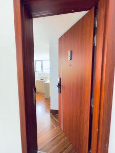 a wooden door in a room with a wooden floor at KSI-HOME Đà Lạt in Khu Chi Lăng