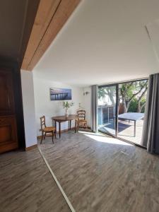 a living room with a table and a sliding glass door at Gîte location de vacances : G2735 in Saint-Maximin-la-Sainte-Baume +8 photos