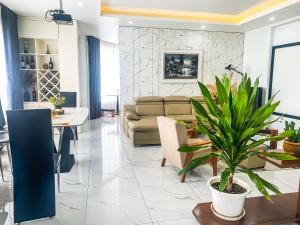 a living room with a couch and a table with a plant at Green Line Long Bien - Serviced Apartment - Ngoc Thuy - Hanoi in Hanoi