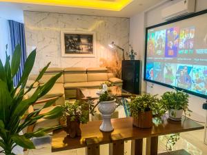a living room with a tv and a table with plants at Green Line Long Bien - Serviced Apartment - Ngoc Thuy - Hanoi in Hanoi
