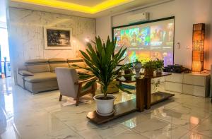 a living room with a couch and a large screen at Green Line Long Bien - Serviced Apartment - Ngoc Thuy - Hanoi in Hanoi