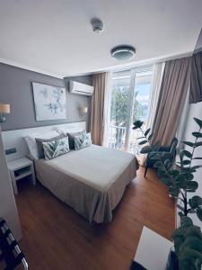 a bedroom with a bed and a large window at Hotel Las Olas in Noja