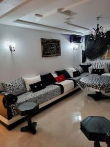 a living room with a black and white couch at rare appartement de vacances in Tangier +17 photos