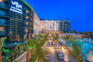 a hotel with a pool and palm trees at night at Vox Maris Resort - Ultra All Inclusive in Side