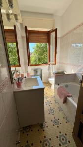 a bathroom with a sink and a tub and a toilet at Casa Odry in Massa +30 photos