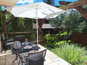 a table with an umbrella on a patio at Studio Dom Nałęczowski in Nałęczów