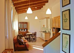 a kitchen and a living room with a table and chairs at Ca' Usignolo in San Ruffillo