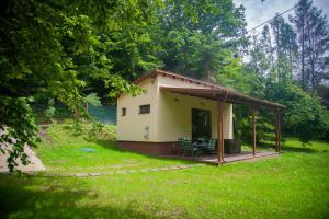 a small house with a deck in a yard at Vízfő Kabin in Sály +9 photos