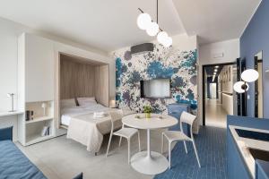 a room with a bed and a table and chairs at Via Fiasella - Le Case di Bart in Genoa +45 photos