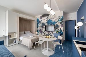 a room with a bed and a table and chairs at Via Fiasella - Le Case di Bart in Genoa