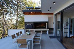 a patio with a table and chairs and a fireplace at Copanjek Country House in Plešivica