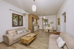 a living room with a couch and a table at Villa Panormo Crete in Panormos Rethymno