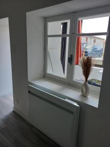 ein Fenster mit einer Vase auf einem Fensterbrett in der Unterkunft Amelixis in Chaillé-les-Marais + 4 Fotos