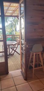 a room with a chair and a table on a deck at Meublé saisonnier in Sainte-Marie