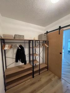 a room with a walk in closet with wooden floors at Hossegor Vue Océan in Soorts-Hossegor