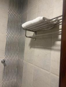 a towel rack in a bathroom with a towel at Ramis Furnished Units in Buraydah