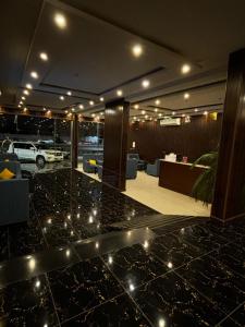 a lobby with a table with lights on it at Ramis Furnished Units in Buraydah