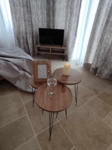 a living room with two tables and a television at Rozas house in Benitses