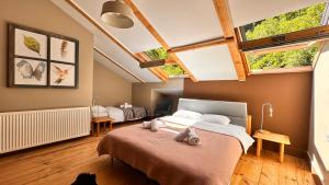 a bedroom with two beds and two windows at Nordic Otel in Çamlıhemşin