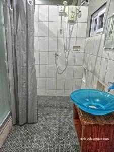 a bathroom with a shower and a blue tub at Playa de Bombora Inn in Cabugao +252 photos