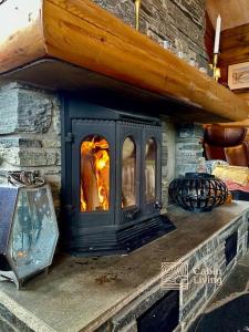 a stone oven with a fire inside of it at Large log cabin at Sjusjøen with sauna, fireplace and panoramic view in Ringsaker +28 photos