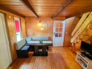 a living room with a table and a couch at Domki Pod Kamieniem in Podgórze