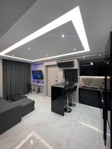 a large room with a kitchen and a living room at The Absolute Luxury Apartment in Kalamata