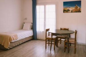 a bedroom with a table and a bed and a table and chairs at Creste E Mare in Ajaccio
