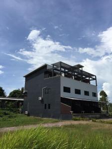 a large building with a roof on top of it at Lanta Manta Apartment in Ko Lanta
