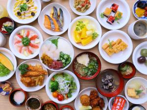 a bunch of plates of food on a table at Dormy Inn Aomori Natural Hot Spring in Aomori
