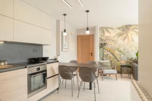 a kitchen with a table and chairs in a room at Apartamento Serea in Villanueva de Arosa