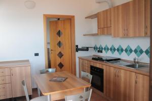 a kitchen with a table and a sink and a stove at Trasimeno Nature house in Castiglione del Lago +25 photos