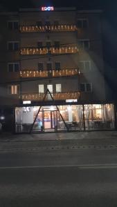 a building with a lit up facade at night at EDO'S in Borşa