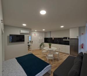 a living room with a couch and a table at Pretas Village Flats in Funchal +13 photos