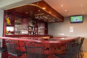 a bar in a restaurant with a red counter and chairs at The Durban Hotel Guyana INC. in Georgetown