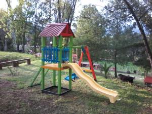 a playground with a slide in a park at Granja el Milagro - Cabañas Campestres in Tibasosa