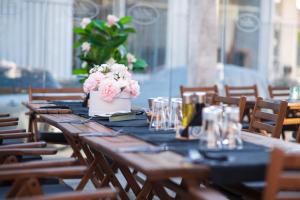 a wooden table with flowers on top of it at Adeti Residence in Nesebar