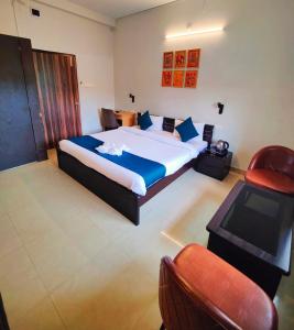 a bedroom with a large bed and a television at 488, The Nook in Bhubaneshwar